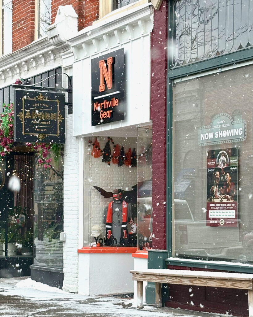 Northville Gear storefront in Downtown Northville during winter snowfall, photographed by Jeremy Thomas Photography