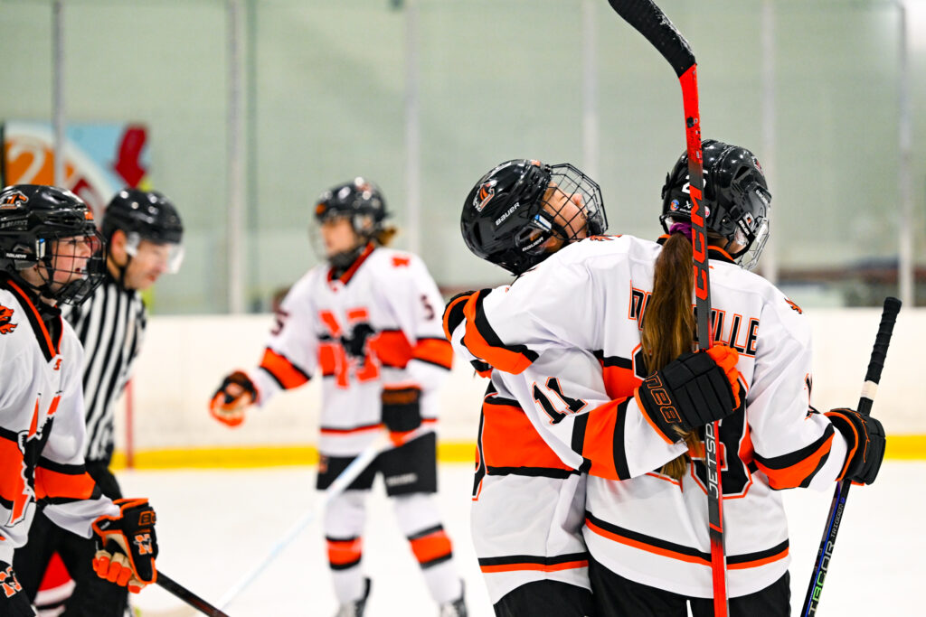 Northville Mustangs Girls Ice Hockey celebration on the ice.