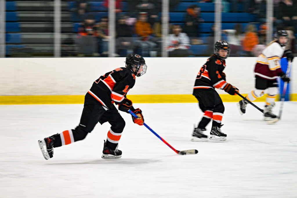 Northville Mustangs Girls Ice Hockey game action shot.